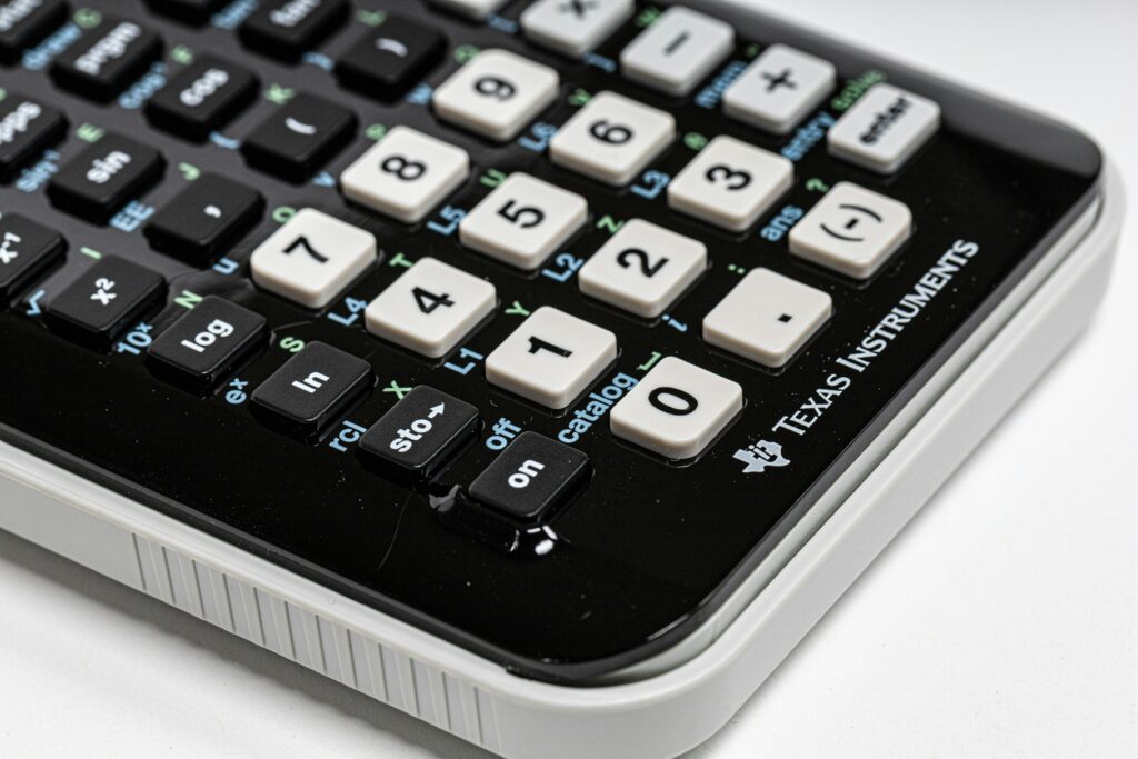 Close-up of a Texas Instruments scientific calculator, showing the keypad with various function and number buttons—a handy tool for real estate professionals and home buyers seeking precise calculations during home buying help.